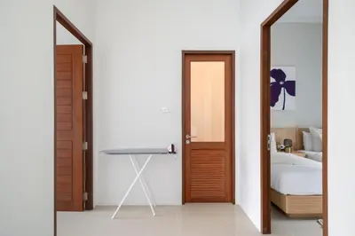 a bedroom with a mirror and a bed and a table at Laguna Beach Villa Phuket 207byน้องมังคุด in Ban Pak Lak