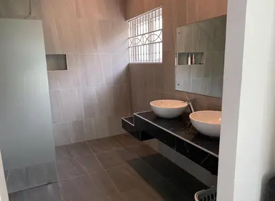 a bathroom with two sinks and a mirror at Pool Villa in Thalang in Ban Na Nai
