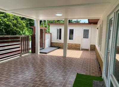 an empty patio with a porch and a house at Pool Villa in Thalang in Ban Na Nai