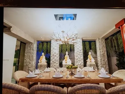 a dining room with a table with a wedding cake at Villa in the Park, Surin Beach, Phuket in Surin Beach