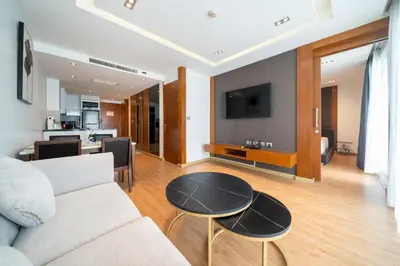 a living room with a couch and a table at Spacious apartment with ocean view & jacuzzi in Patong Beach