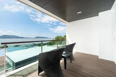 a balcony with a view of the water at Spacious apartment with ocean view & jacuzzi in Patong Beach
