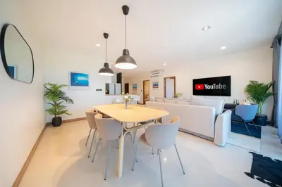 a living room with a table and a couch at 3BR Suite Surin Beach Phuket - Near 2 beaches in Surin Beach