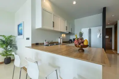 a kitchen with a bowl of fruit on a counter at 3BR Suite Surin Beach Phuket - Near 2 beaches in Surin Beach