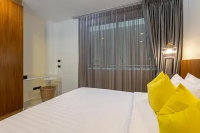a bedroom with a large white bed with a window at 3BR Suite Surin Beach Phuket - Near 2 beaches in Surin Beach