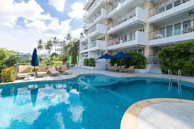 a swimming pool in front of a building at 3BR Suite Surin Beach Phuket - Near 2 beaches in Surin Beach