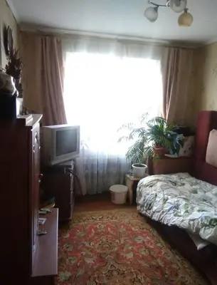 a bedroom with a bed and a tv and a window at Dimadom in Patong Beach