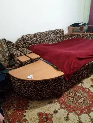 a cheetah couch sitting in a living room with at Dimadom in Patong Beach