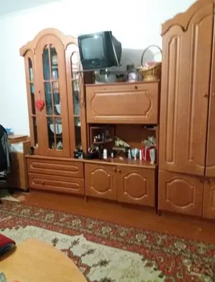 a living room with a tv and a wooden cabinet at Dimadom in Patong Beach