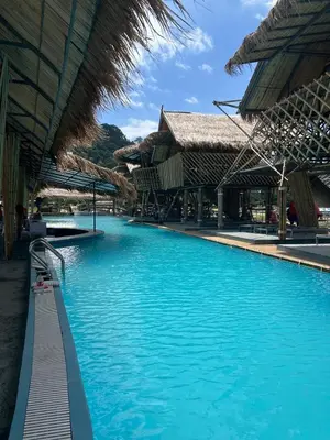 a swimming pool with blue water in a resort at Thailand Mountain Phuket in Patong Beach