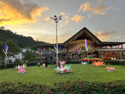 a park with colorful kites in front of a building at Thailand Mountain Phuket in Patong Beach