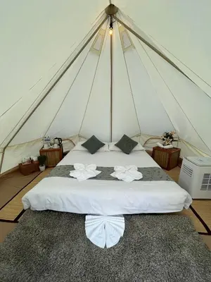 a bedroom with a white bed in a tent at Thailand Mountain Phuket in Patong Beach