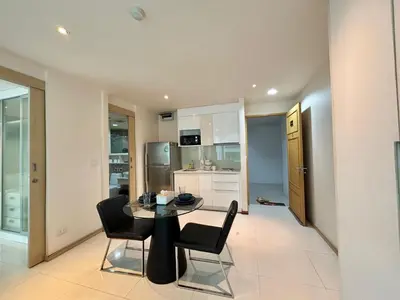 a kitchen and dining room with a table and chairs at 1 bedroom walk to Kalim in Patong Beach