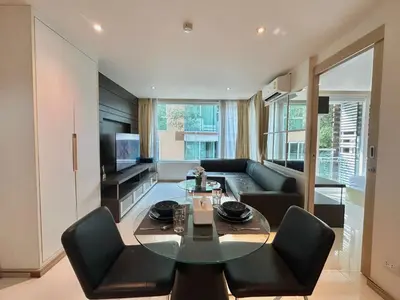 a living room with a table and a couch at 1 bedroom walk to Kalim in Patong Beach