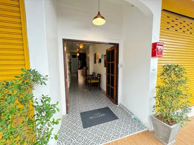 a hallway of a house with a door and plants at Pupa Women Hostel in Patong Beach