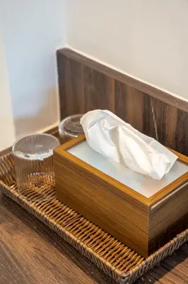 a wooden tray with a napkin on top of it at The Pinnacle Katanoi in Kata Beach