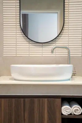 a bathroom with a white sink and a mirror at The Pinnacle Katanoi in Kata Beach