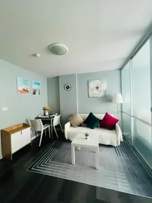 a living room with a couch and a table at Pool View Apartments-Kathu,Phuket in Kathu