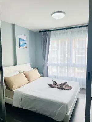 a bedroom with a white bed with a window at Pool View Apartments-Kathu,Phuket in Kathu