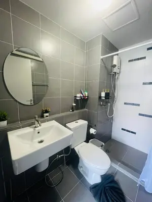 a bathroom with a white toilet and a sink at Pool View Apartments-Kathu,Phuket in Kathu