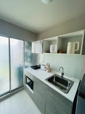 a small kitchen with a sink and a window at Pool View Apartments-Kathu,Phuket in Kathu