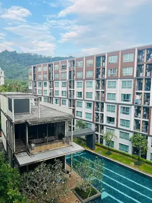 an apartment building with a swimming pool in front of it at Pool View Apartments-Kathu,Phuket in Kathu