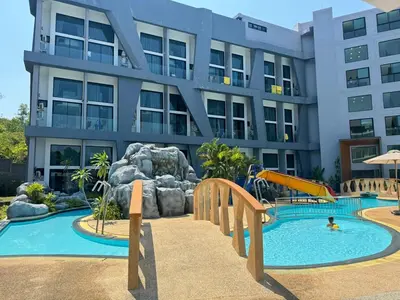 a resort with a pool and a slide at Utopia Loft Condo in Nai Harn Beach