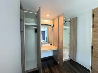 a bathroom with a vanity and a mirror in a room at Utopia Loft Condo in Nai Harn Beach