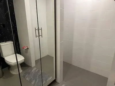 a bathroom with a toilet and a glass shower at 1-bedroom apartment Naiharn Beach B403 in Rawai Beach
