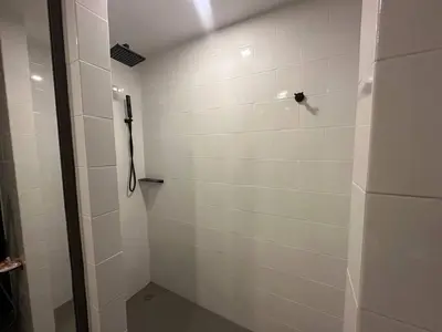 a bathroom with a shower with a black shower head at 1-bedroom apartment Naiharn Beach B403 in Rawai Beach