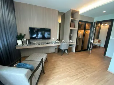 a living room with a couch and a television in a hotel room at villa kamala regent 2 bedrooms in Kamala Beach