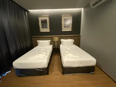two beds in a small room with swans on them at villa kamala regent 2 bedrooms in Kamala Beach
