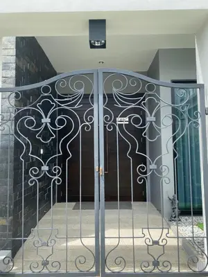 a door with a wrought iron gate in a building at villa kamala regent 2 bedrooms in Kamala Beach