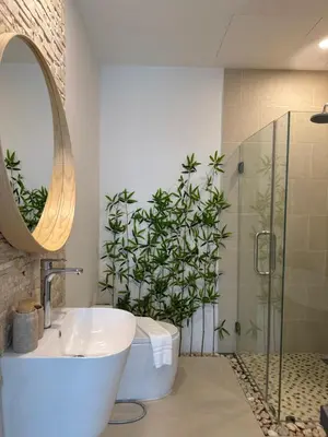 a bathroom with a tub and a plant in the shower at Luxury 3BR Triplex Jacuzzi & Sea View PANDORA RESIDENCES in Nai Harn Beach