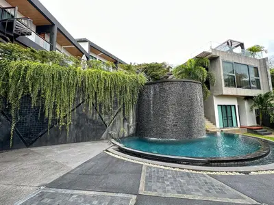 a swimming pool in front of a building at Luxury 3BR Triplex Jacuzzi & Sea View PANDORA RESIDENCES in Nai Harn Beach
