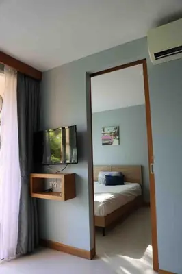 a mirror in a bedroom with a bed and a tv at Two Room MiamiStyle Perfect for Digital Nomads in Ban Saiyuan (1)