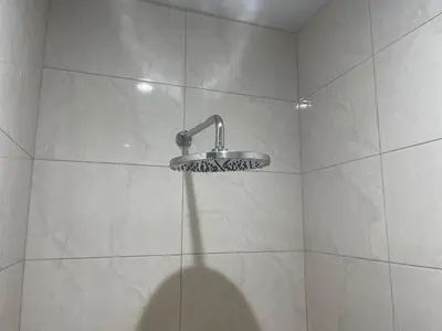 a shower with a shower head in a bathroom at Two Room MiamiStyle Perfect for Digital Nomads in Ban Saiyuan (1)