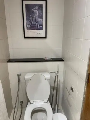 a bathroom with a toilet with a picture on the wall at Two Room MiamiStyle Perfect for Digital Nomads in Ban Saiyuan (1)