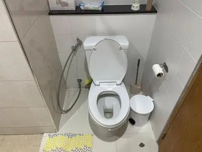a small bathroom with a toilet and a shower at Two Room MiamiStyle Perfect for Digital Nomads in Ban Saiyuan (1)