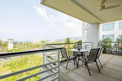 a balcony with a table and chairs and a view at Exquisite Sea View Luxury Apartment Veloche group in Karon Beach