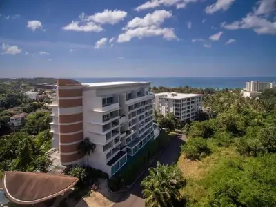 an aerial view of a building with the ocean in the background at Exquisite Sea View Luxury Apartment Veloche group in Karon Beach