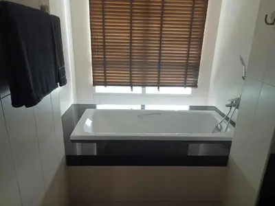 a bath tub in a bathroom with a window at Exquisite Sea View Luxury Apartment Veloche group in Karon Beach