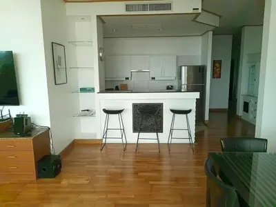 a kitchen with a counter and stools in a room at Exquisite Sea View Luxury Apartment Veloche group in Karon Beach