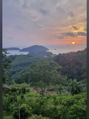 a sunset in the jungle with a view of the ocean at Sea True Valley Phuket ซี ทรู วัลเลย์ ภูเก็ต in Ban Ao Makham