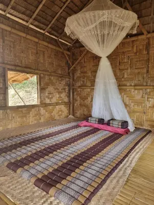 a bed in a room with a mosquito net at Sea True Valley Phuket ซี ทรู วัลเลย์ ภูเก็ต in Ban Ao Makham