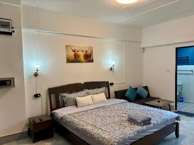 a bedroom with a bed in a room at Kimchi Apartment in Patong Beach