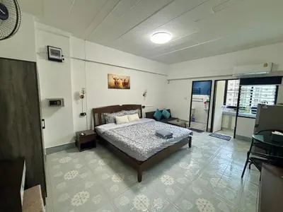 a bedroom with a bed in a room at Kimchi Apartment in Patong Beach