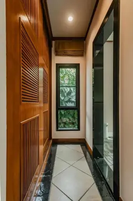 a hallway with a door and a window at Rose Pool Villa The perfect private oasis in Rawai Beach