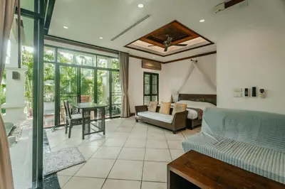 a living room with a couch and a table at Rose Pool Villa The perfect private oasis in Rawai Beach