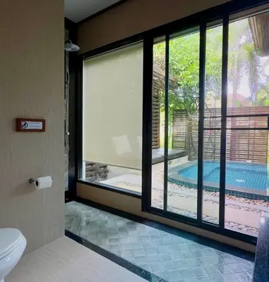a bathroom with a window with a view of a pool at Rose Pool Villa The perfect private oasis in Rawai Beach